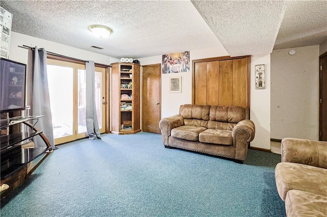 carpeted living area with visible vents, baseboards, and a textured ceiling