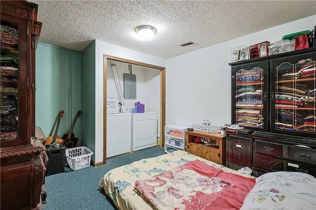 carpeted bedroom featuring electric panel, separate washer and dryer, visible vents, and a textured ceiling