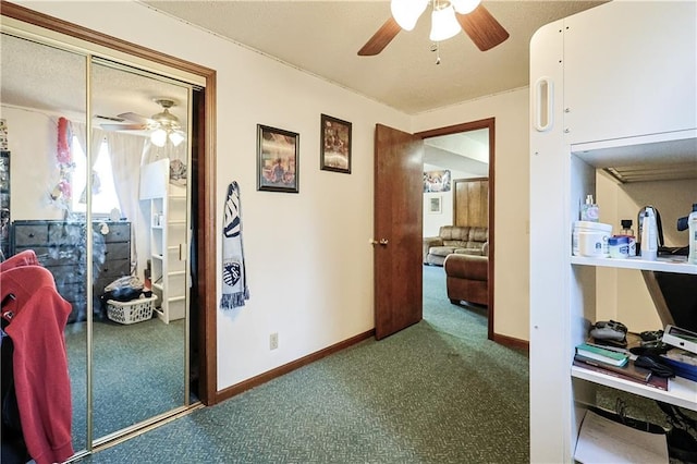 corridor featuring baseboards and carpet