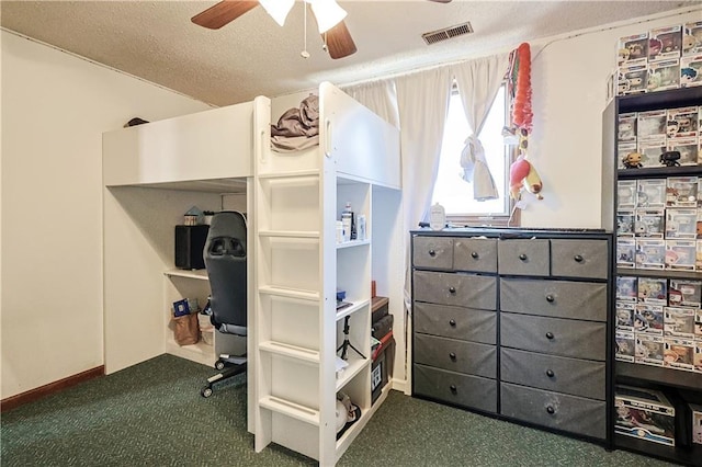 carpeted bedroom featuring ceiling fan, visible vents, and a textured ceiling