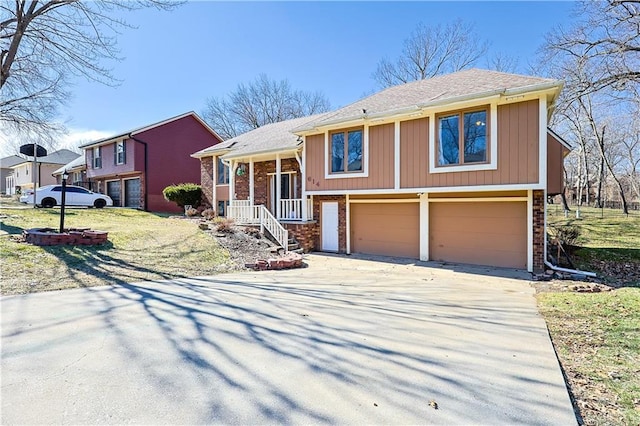 view of front facade featuring an attached garage, brick siding, and driveway