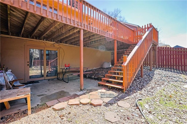 view of patio / terrace featuring stairs and fence