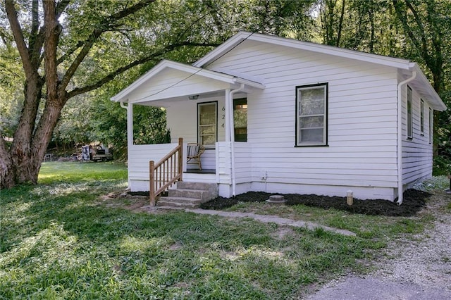 bungalow-style house with a porch and a front yard