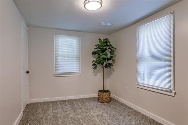 carpeted empty room with baseboards and visible vents