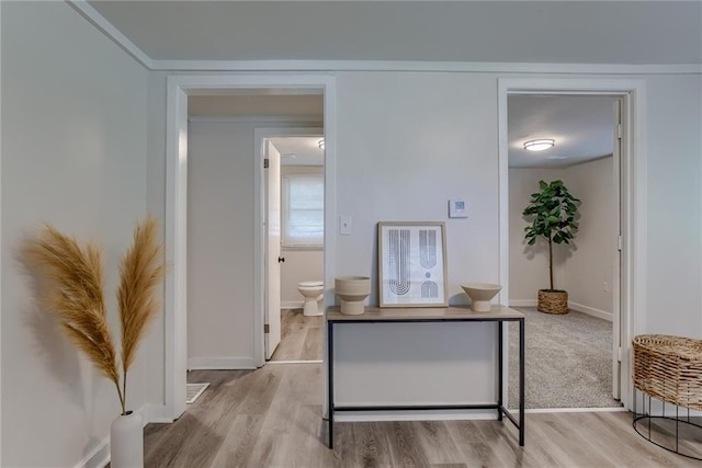 interior space with baseboards and wood finished floors