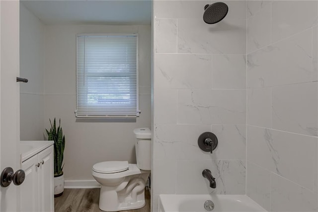 full bathroom with toilet, vanity, wood finished floors,  shower combination, and baseboards