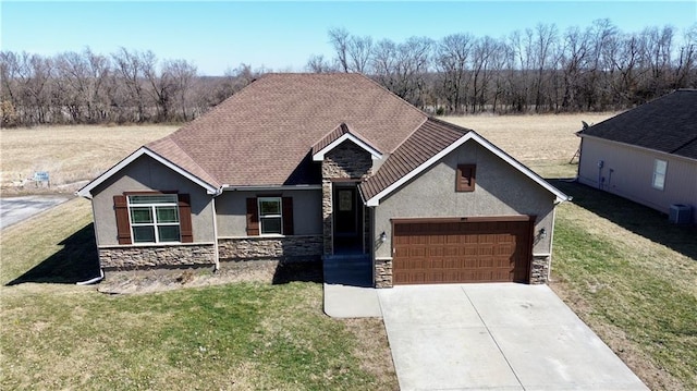 view of front of house with a garage, stone siding, and a front yard