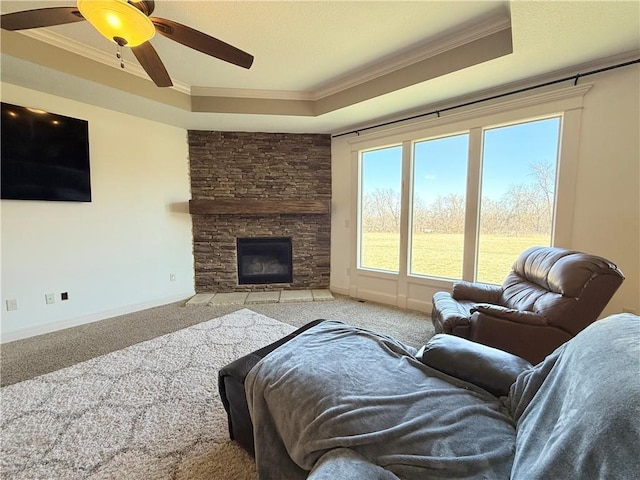 carpeted living area with a raised ceiling and ornamental molding