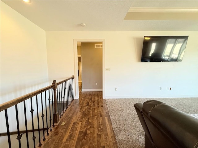 interior space with dark wood-type flooring, baseboards, and visible vents