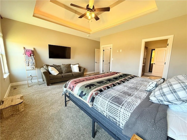 bedroom with baseboards, a raised ceiling, a ceiling fan, and carpet flooring