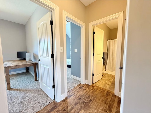 hall featuring wood finished floors and baseboards