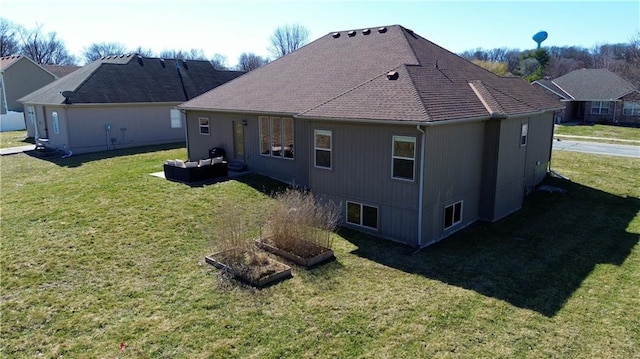 back of property with an outdoor living space and a yard