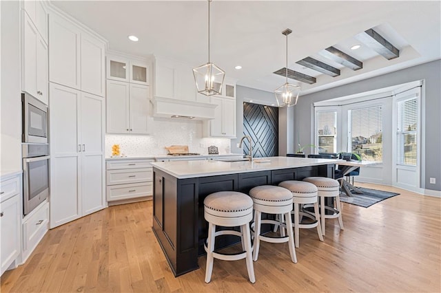 kitchen with a sink, tasteful backsplash, appliances with stainless steel finishes, and light countertops