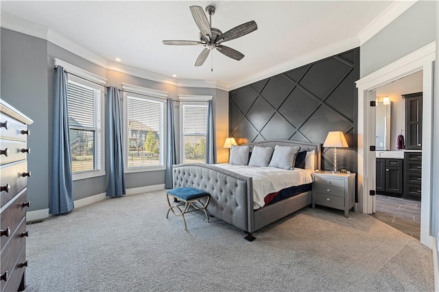 bedroom with baseboards, light colored carpet, ornamental molding, and an accent wall