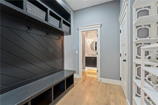 mudroom featuring baseboards and light wood-style floors