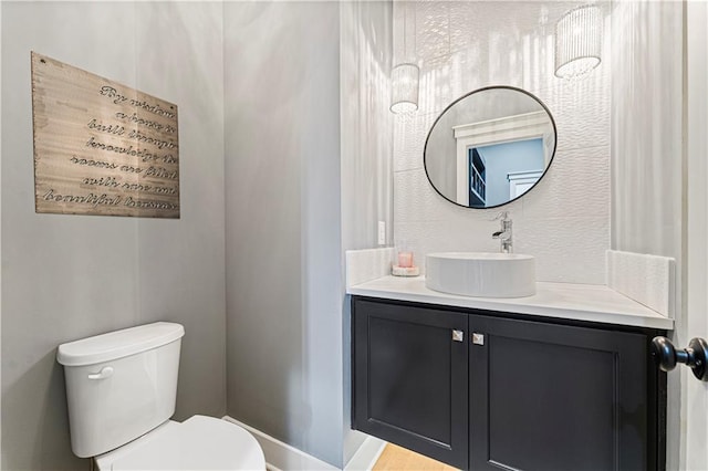 bathroom featuring toilet and vanity