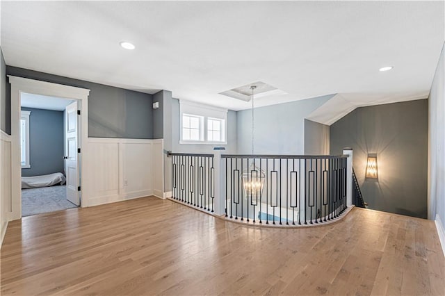 unfurnished room with recessed lighting, a wainscoted wall, and wood finished floors