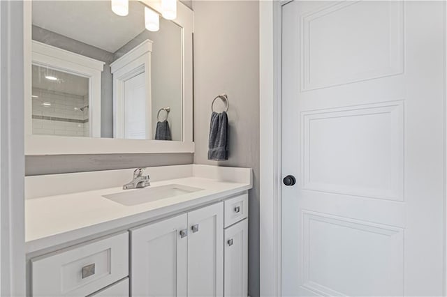 bathroom featuring a shower and vanity