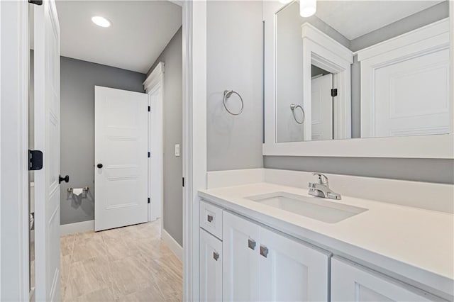 bathroom with vanity and baseboards