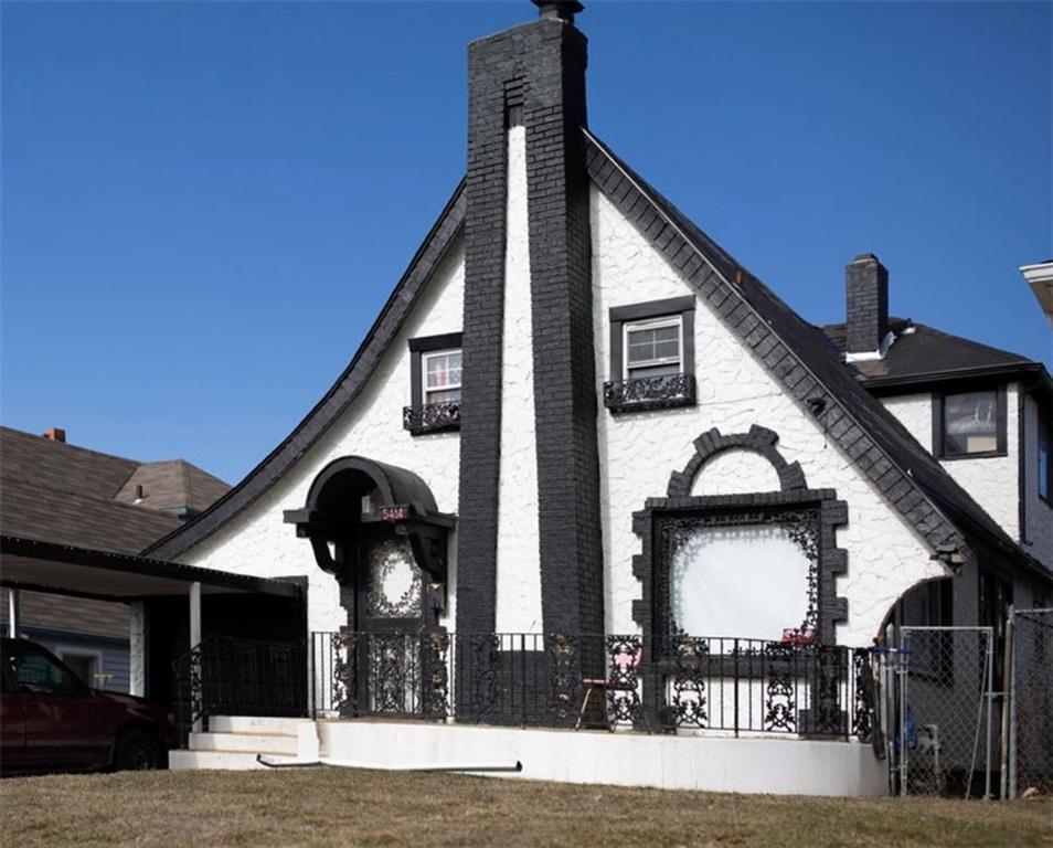 5414 E 23rd St, Kansas City, MO 64127 - exterior space featuring a gate, fence, and a chimney