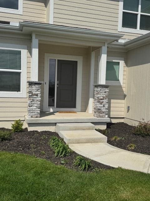 doorway to property featuring stone siding