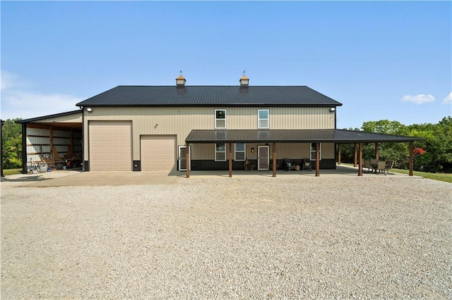 exterior space featuring metal roof and driveway