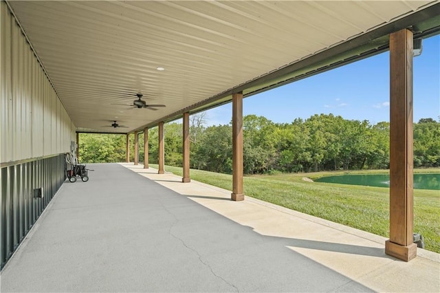 view of patio featuring ceiling fan and a water view