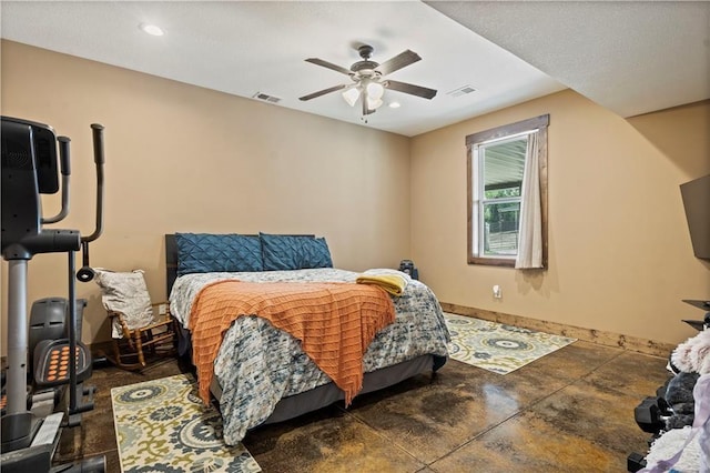 bedroom featuring concrete flooring, visible vents, baseboards, and a ceiling fan