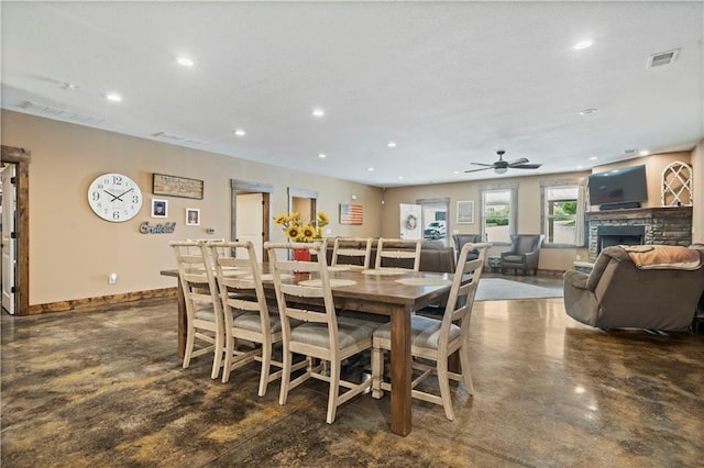 dining space featuring ceiling fan, recessed lighting, a fireplace, visible vents, and baseboards