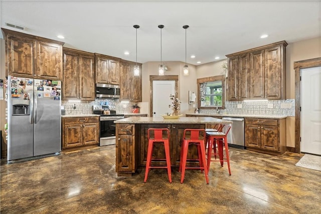 kitchen featuring stainless steel appliances, visible vents, a center island, tasteful backsplash, and finished concrete floors