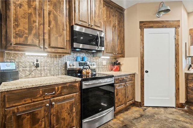 kitchen with stainless steel appliances, backsplash, and light stone countertops