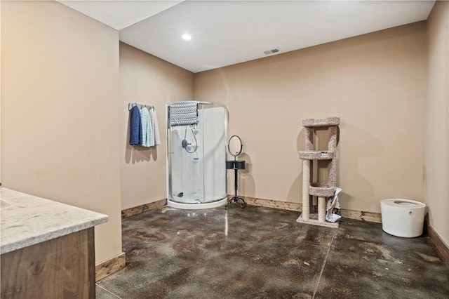 interior space featuring visible vents, concrete floors, and baseboards