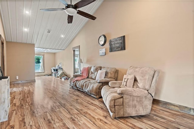 living area with visible vents, a ceiling fan, wood finished floors, high vaulted ceiling, and baseboards