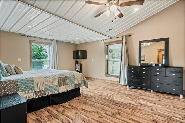 bedroom with lofted ceiling, visible vents, a ceiling fan, wood finished floors, and access to outside