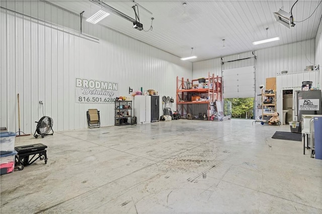 garage with a garage door opener and metal wall