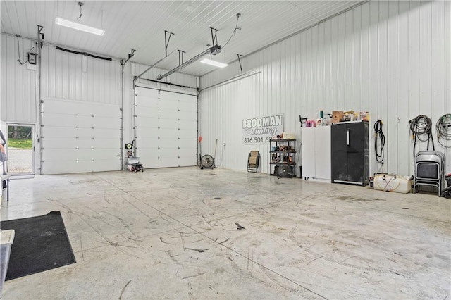 garage with metal wall and a garage door opener