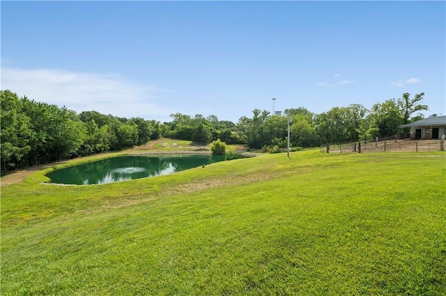 view of yard featuring a water view and fence