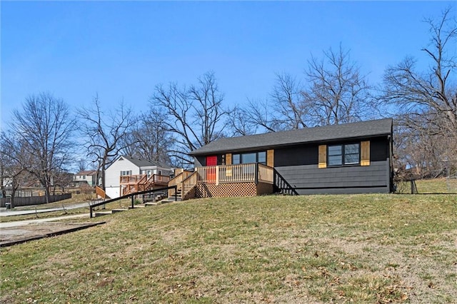 view of front of house with a wooden deck and a front lawn