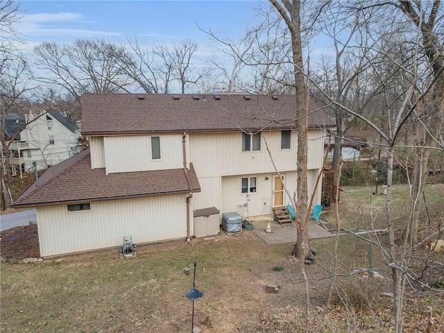 756 NW S Shore Dr, Lake Waukomis, MO 64151 - back of property with a shingled roof, a patio area, entry steps, and a yard