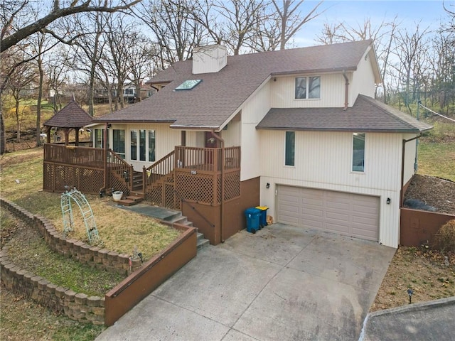 756 NW S Shore Dr, Lake Waukomis, MO 64151 - view of front facade with roof with shingles, an attached garage, driveway, and a chimney