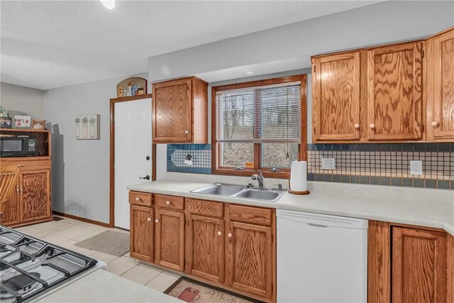 756 NW S Shore Dr, Lake Waukomis, MO 64151 - kitchen with dishwasher, black microwave, a sink, light countertops, and decorative backsplash