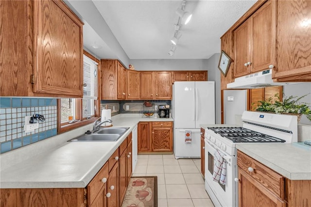 756 NW S Shore Dr, Lake Waukomis, MO 64151 - kitchen with white appliances, brown cabinets, a sink, and light countertops