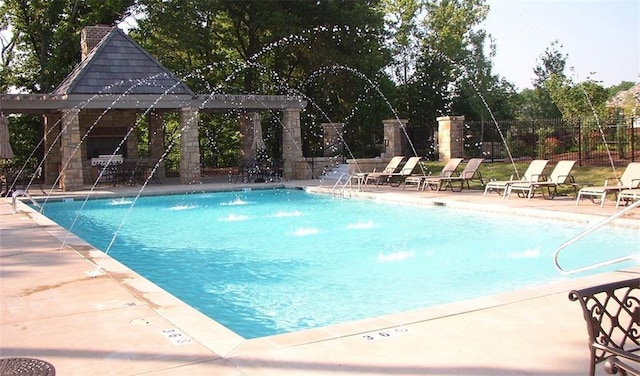 pool featuring a patio area and fence