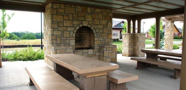 view of patio with an outdoor fireplace