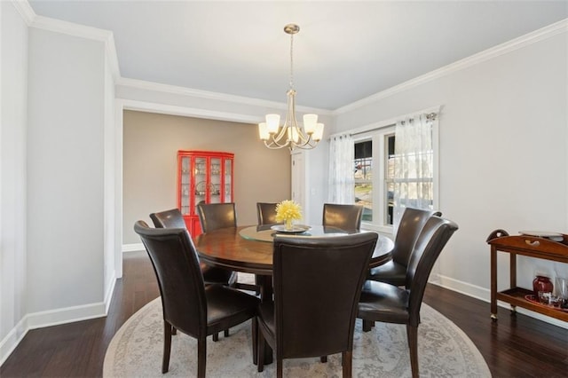 dining area with baseboards, crown molding, an inviting chandelier, and wood finished floors