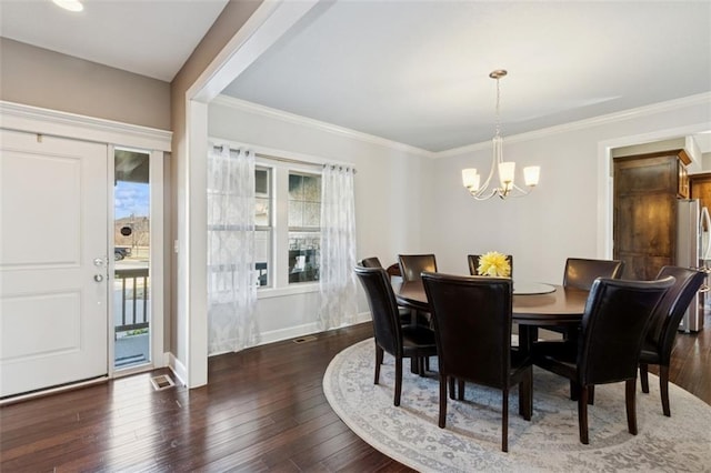 dining space featuring baseboards, crown molding, an inviting chandelier, and hardwood / wood-style floors