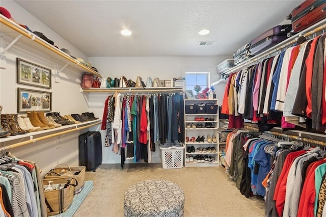 walk in closet featuring visible vents and carpet floors