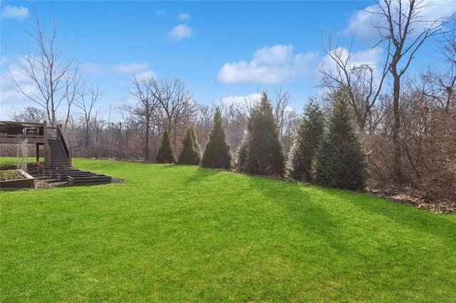 view of yard featuring stairway and a wooden deck