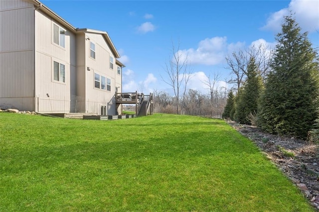 view of yard with stairway and a wooden deck