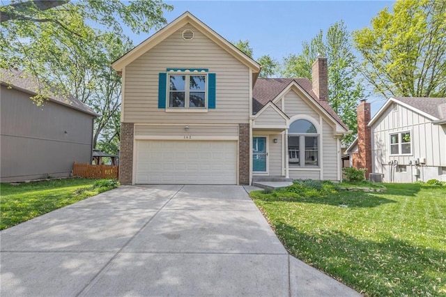 traditional-style home featuring an attached garage, a front lawn, brick siding, a chimney, and driveway